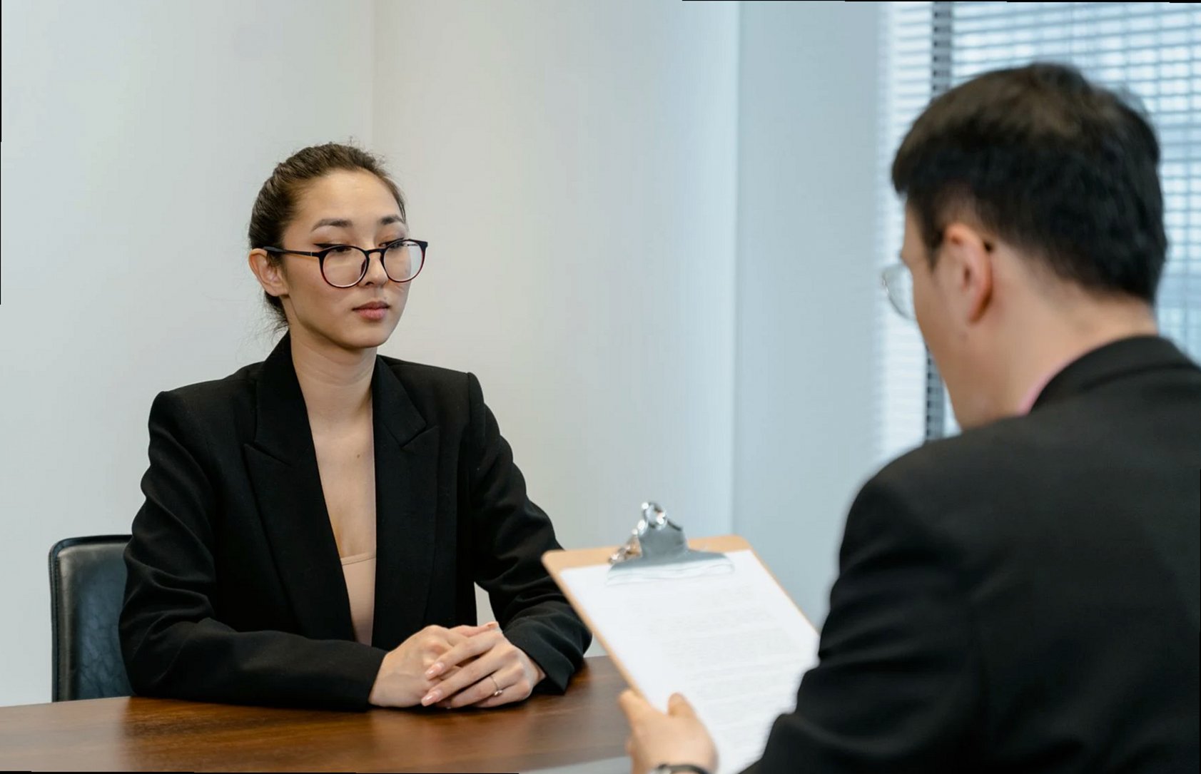 Business interview scene with professionals in office setting.